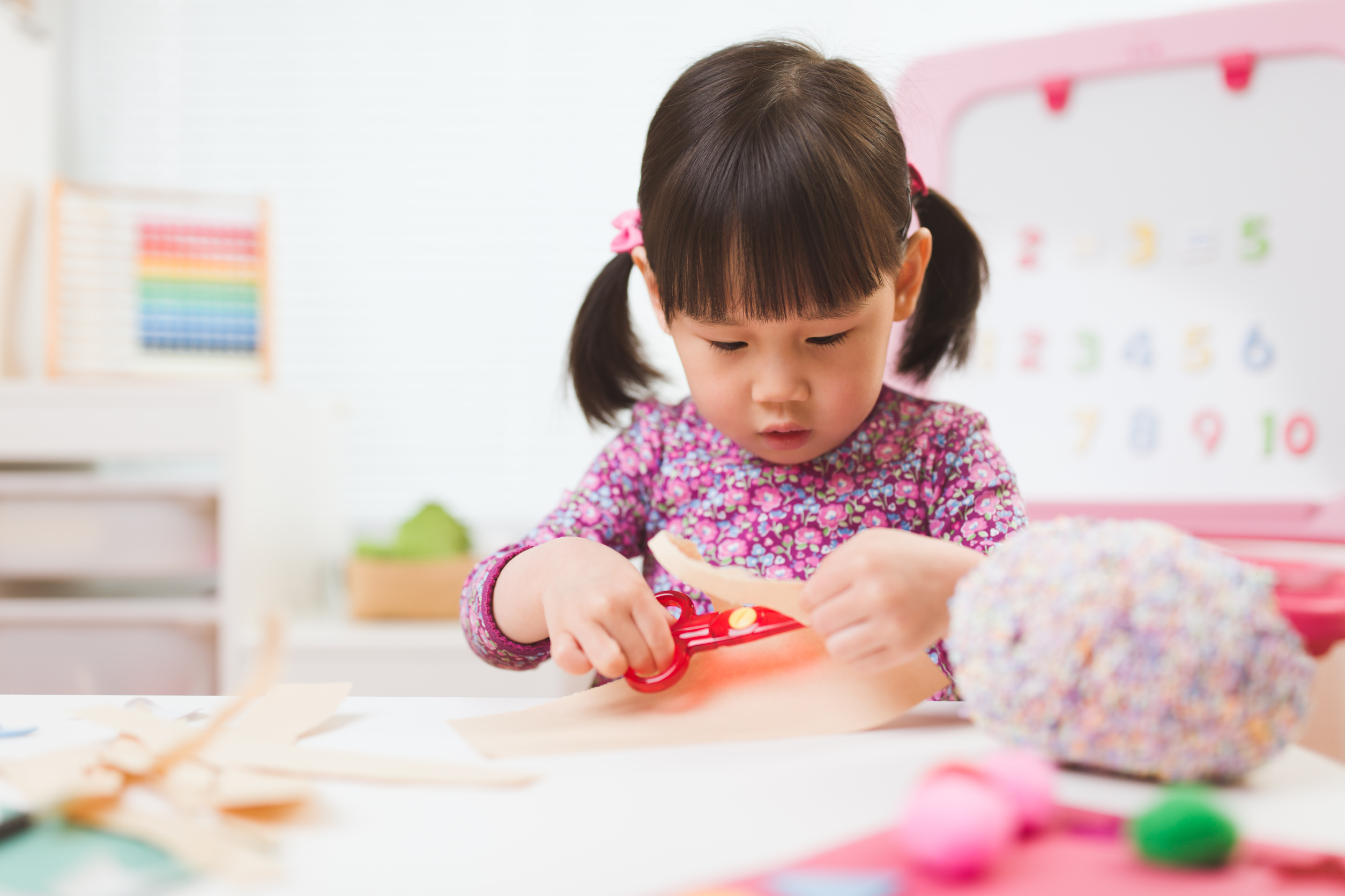 toddler girl  making craft for homeschooling